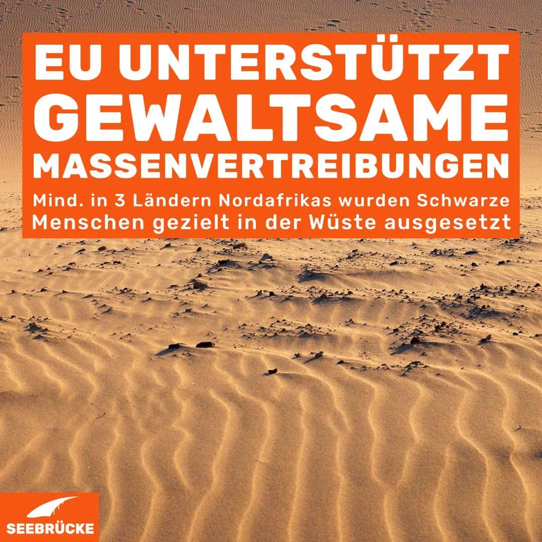  A poster showing a sandy desert with the text: “EU unterstützt gewaltsame Massenvertreibungen. Mind. in 3 Ländern Nordafrikas wurden Schwarze Menschen gezielt in der Wüste ausgesetzt. Seebrücke.”